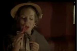 Lydia applies lipstick