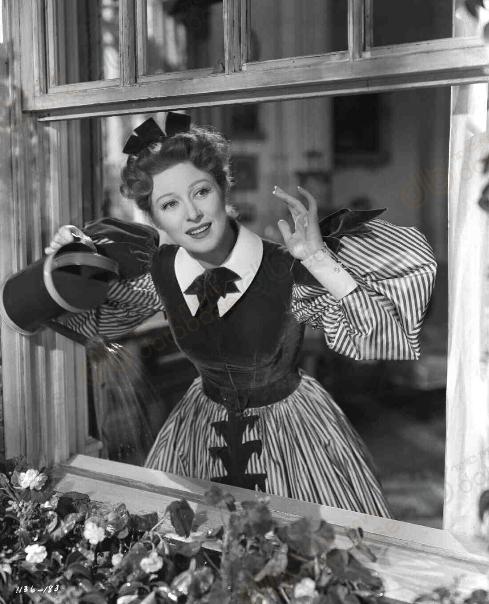 Lizzy at the window looking like a matron in Little Women