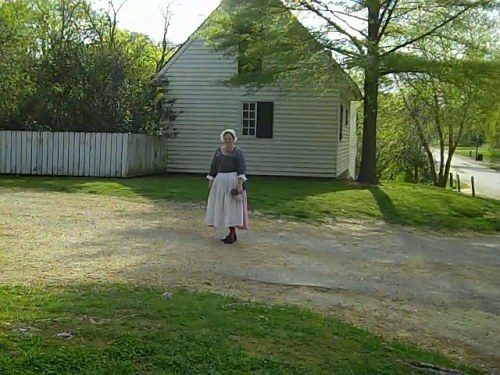 A comely maid walks home after a long day.