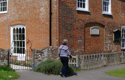 In this image, you can see the window in the drawing room that Edward had blocked up (right), which faced the road, and the fancier window facing the garden. 