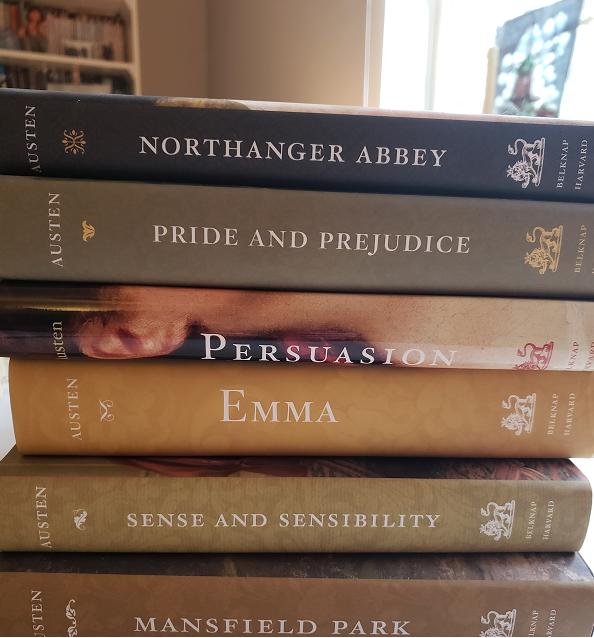 Image of a stack of Jane Austen's six novels, annotated editions by Harvard University Press.