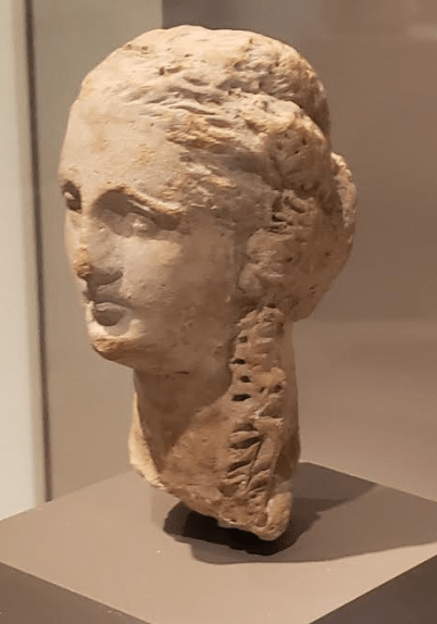 Terracotta Head of a Woman with Long Curls. Greek (South Italy), 3rd century B.C.