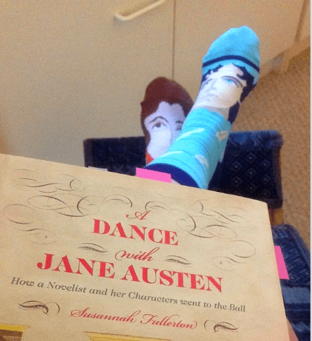 Image of Vic wears rival authors on her feet whilst reading Fullerton's A Dance With Jane Austen.