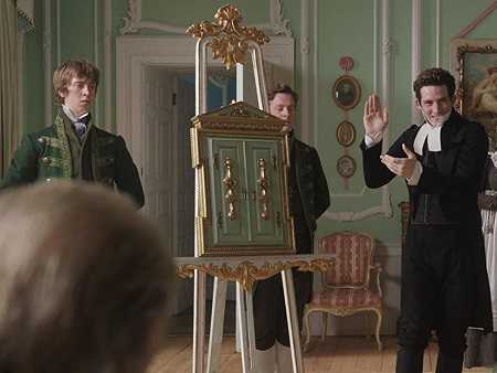 James and Bartholomew flank the frame as Mr Elton is about to reveal its contents.