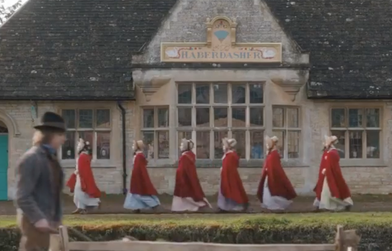 Image of a line of girls in red robes