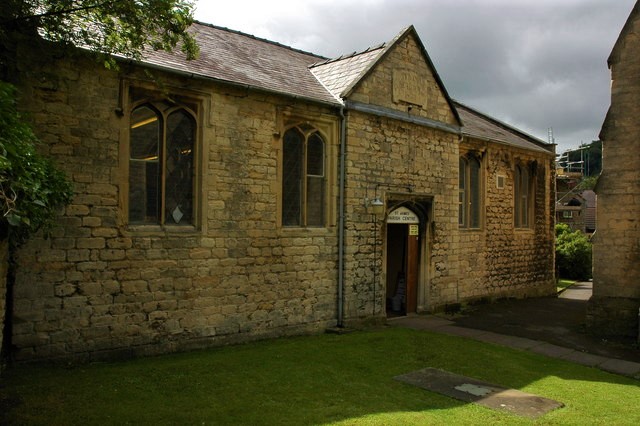 Photograph of the front of a modest stone building